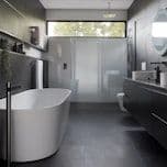 Dark modern bathroom with freestanding tub