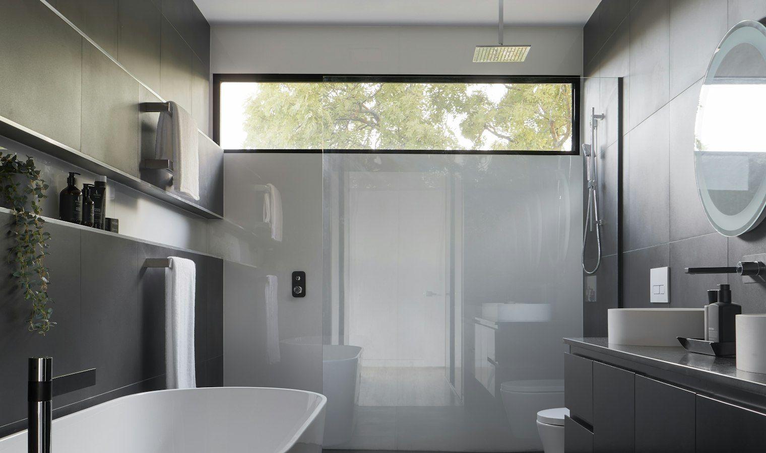 Dark modern bathroom with freestanding tub