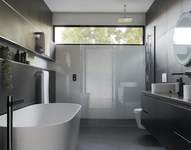 Dark modern bathroom with freestanding tub