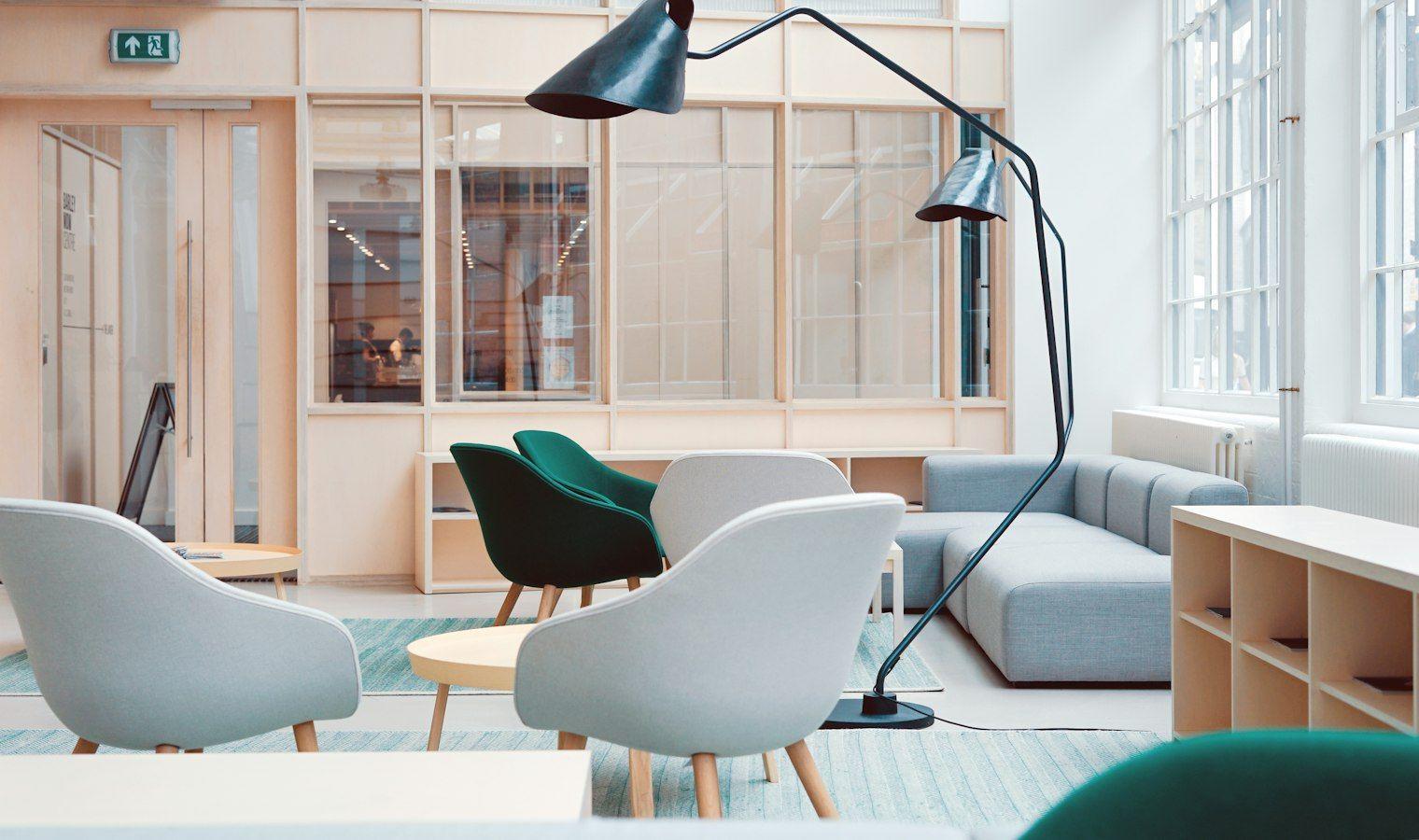 Bright studio office with white chairs and floor lamp