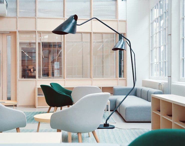 Bright studio office with white chairs and floor lamp