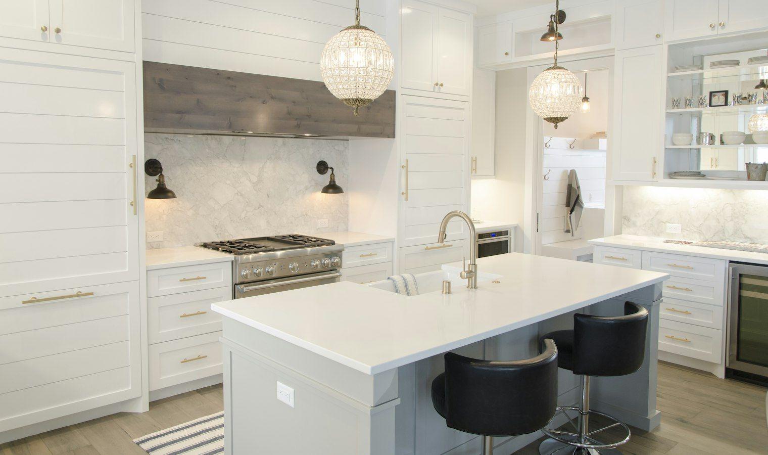White kitchen with glass pendant lights