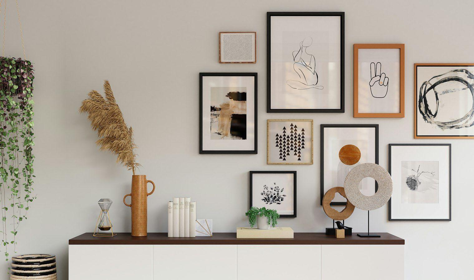 Gallery wall above a white sideboard with dried flowers