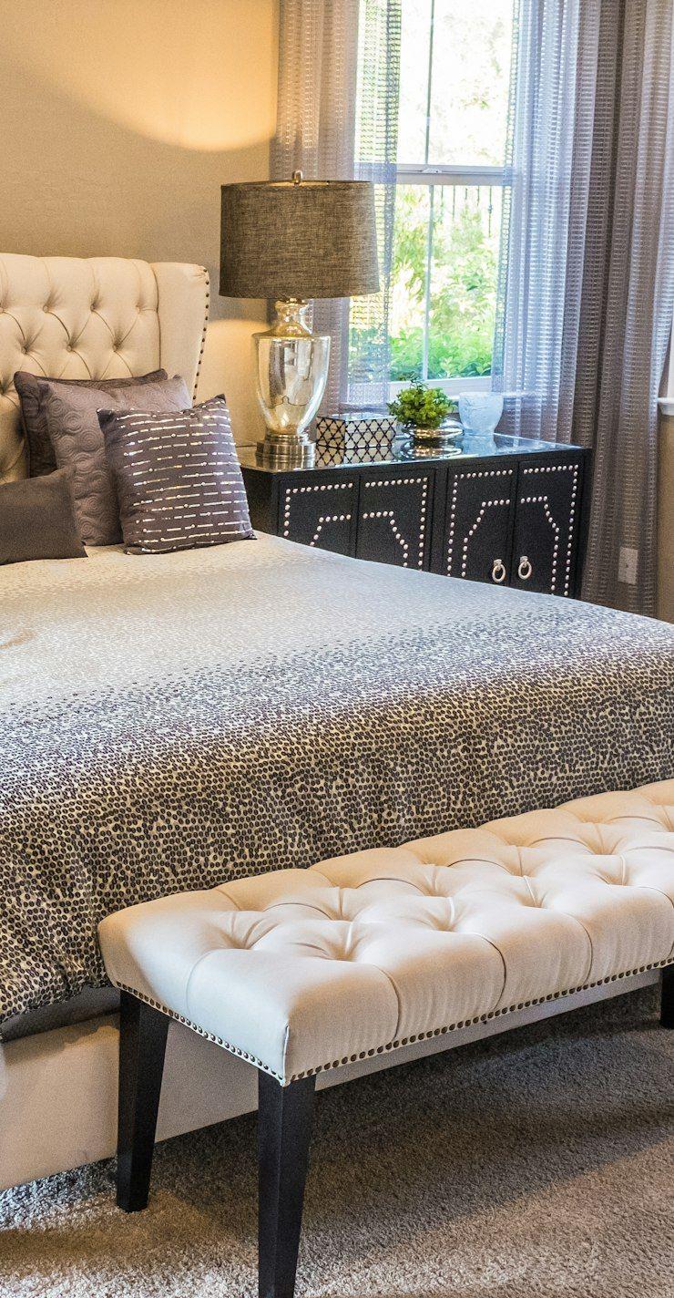 Bedroom with tufted headboard and upholstered bench