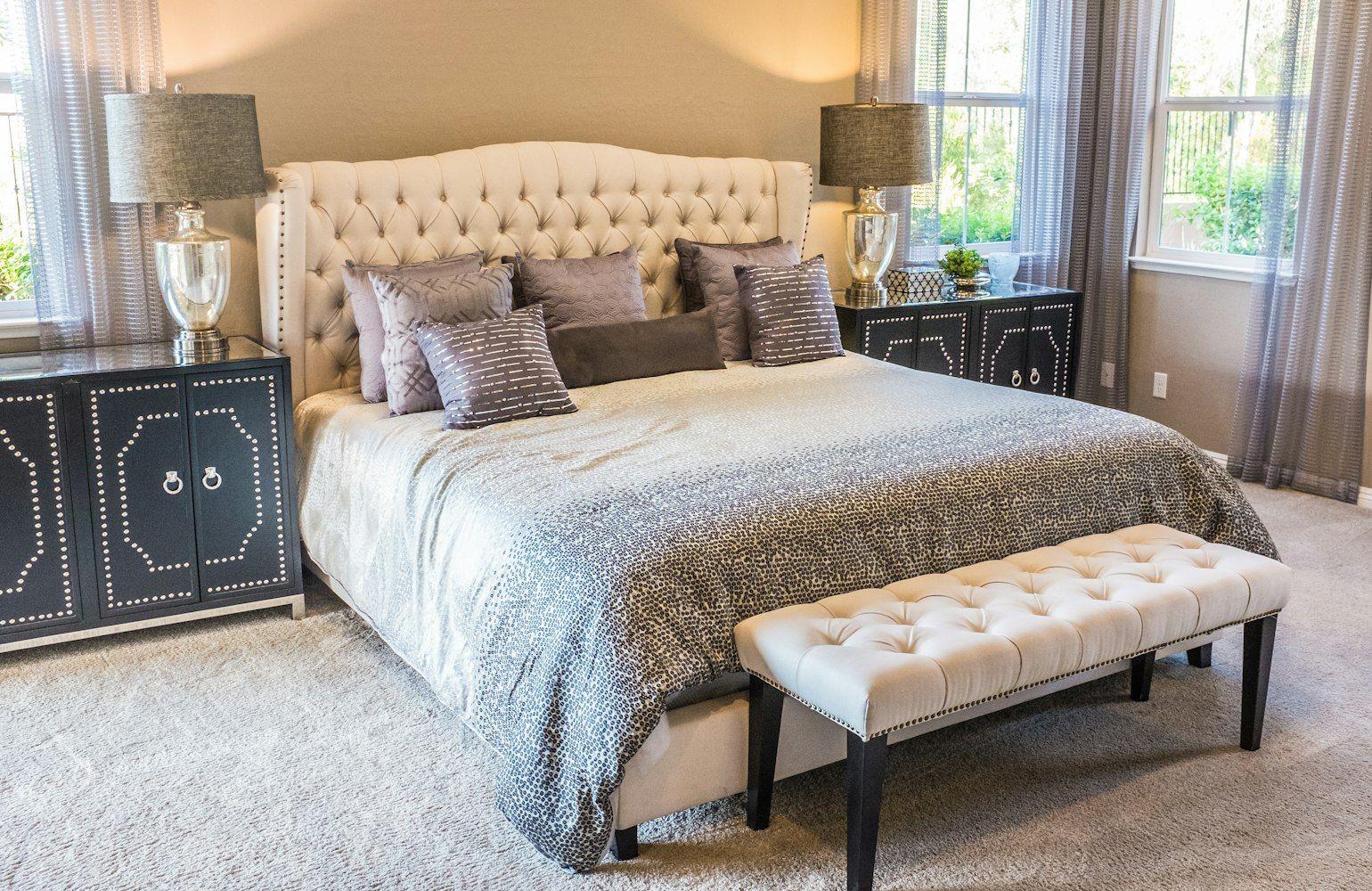 Classic bedroom with tufted headboard and lamps