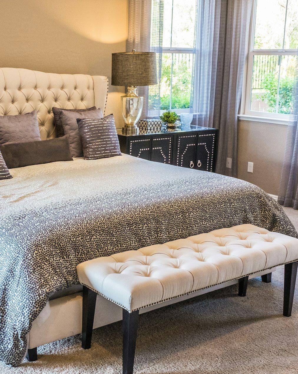 Bedroom with tufted headboard and upholstered bench