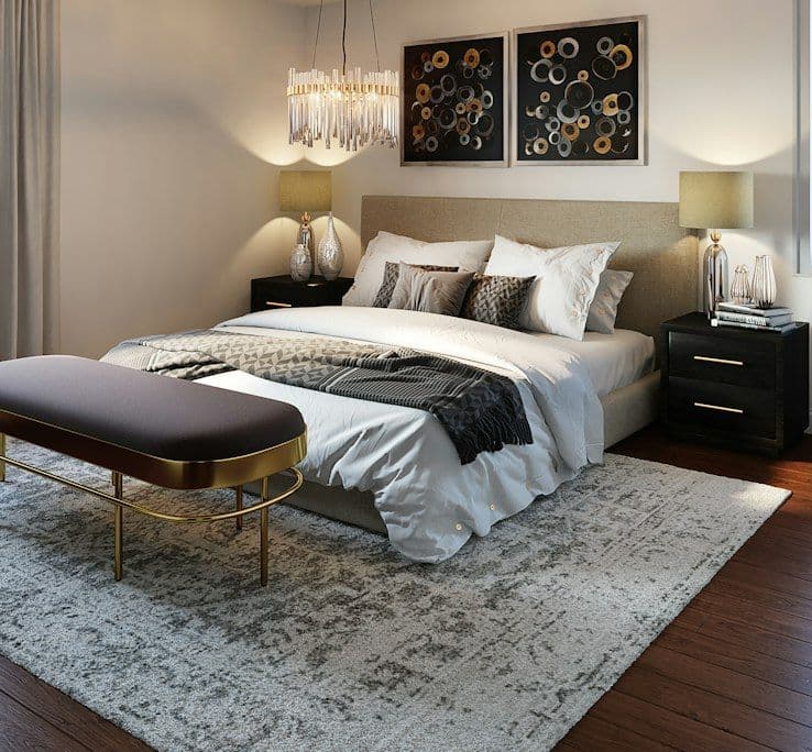 Bedroom with patterned throw and brass lamps