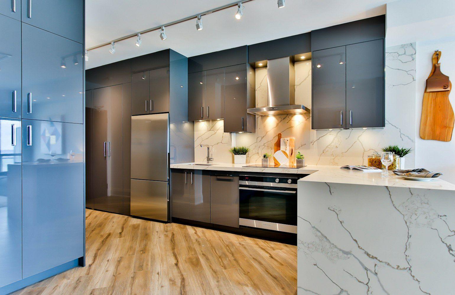 Minimal kitchen with handleless cabinets and oak floor