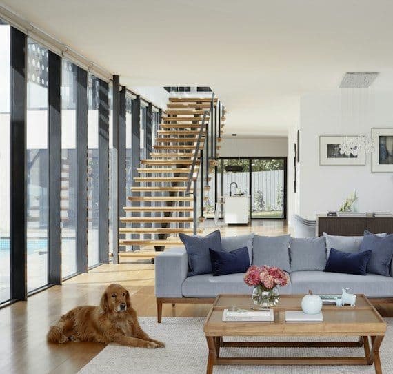 Bright living room with oak staircase and grey sofa